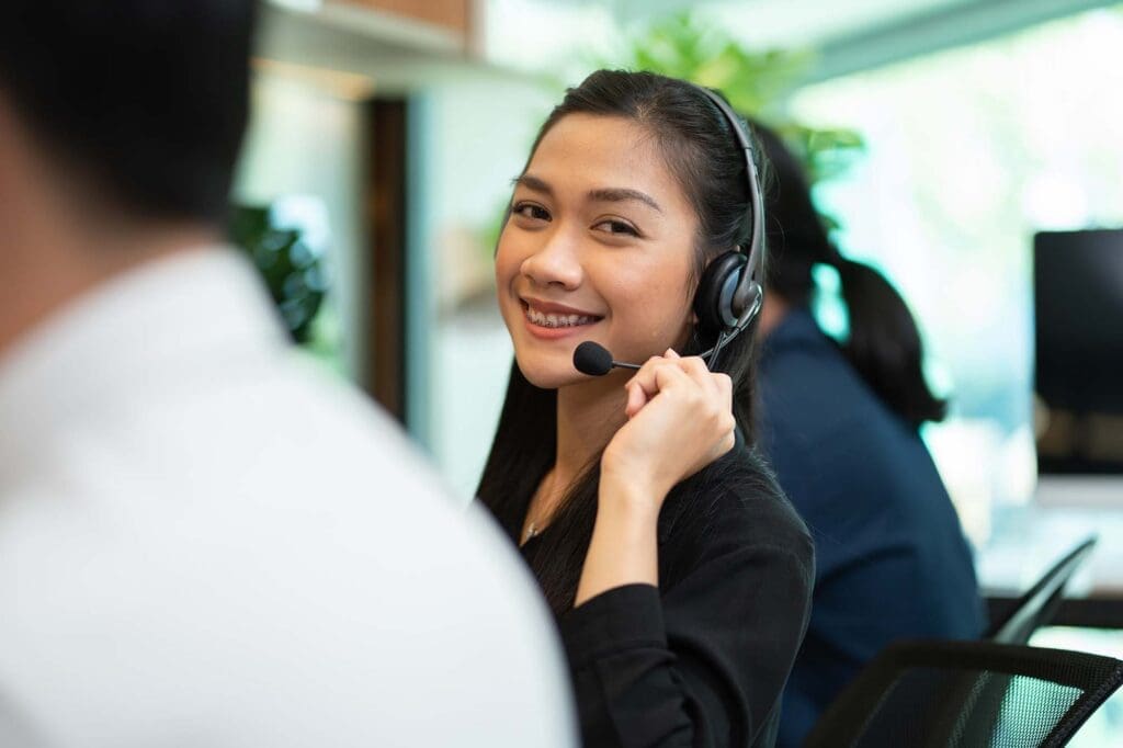 image of female customer support wearing microphone headset talking with customer